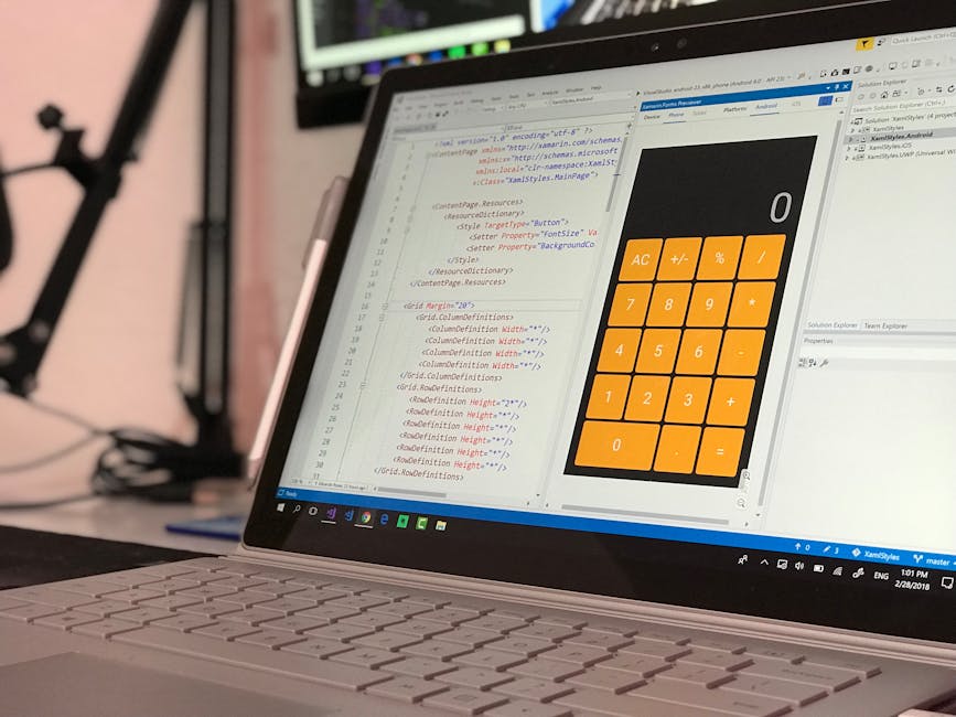 A close-up of a laptop displaying a code editor with HTML and CSS code on the left side and a large, bright orange calculator interface on the right side. The code includes styles for layout and dimen
